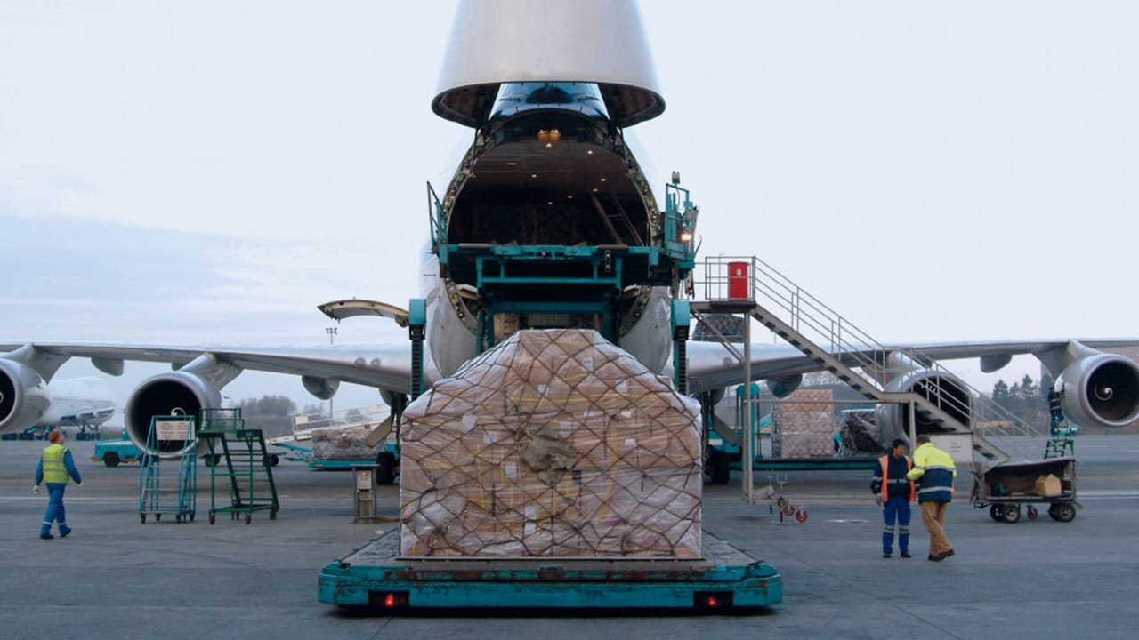 An airplane with a large cargo container positioned on top, showcasing its capacity for freight transport.