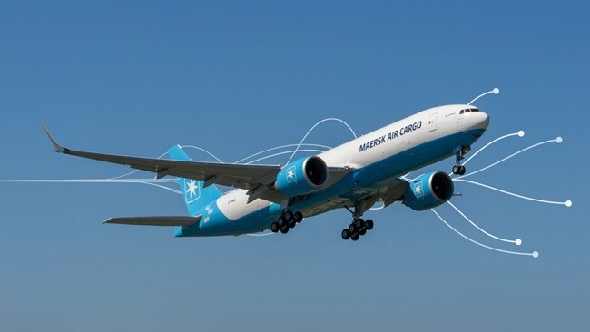 Maersk Air Cargo plane taking off under clear blue sky.