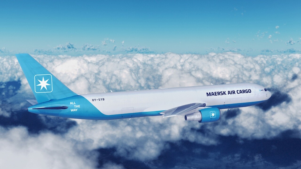 A blue and white airplane soaring through a clear blue sky, showcasing its sleek design and flight capabilities.