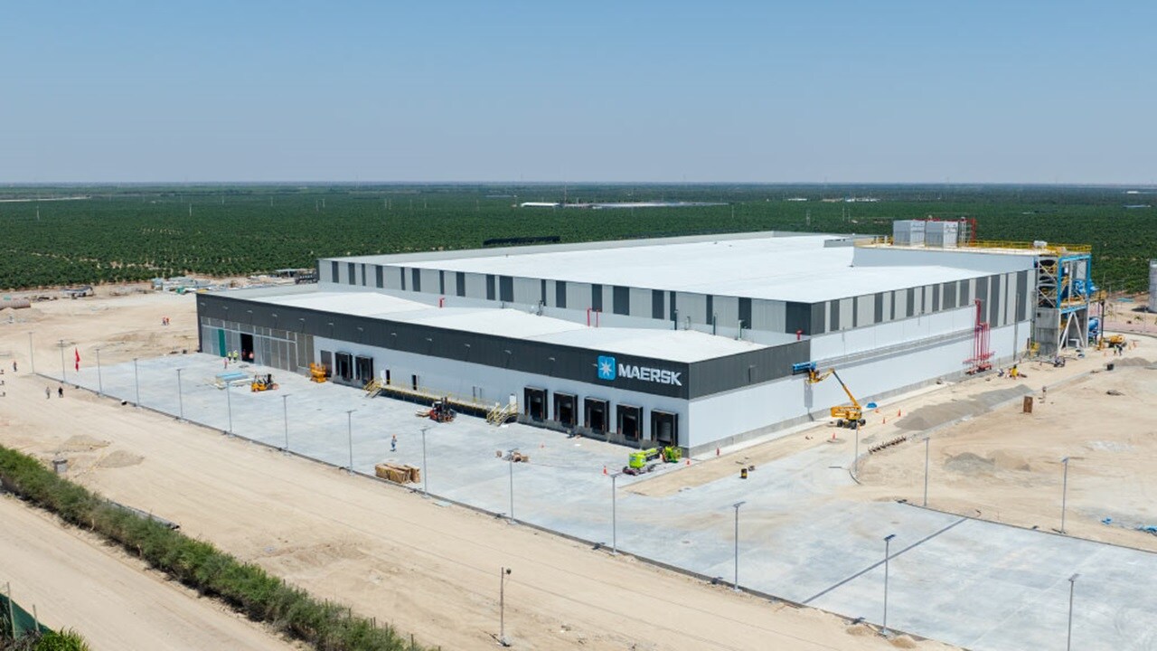 Aerial view of a large building under construction, showcasing scaffolding and machinery on the site.