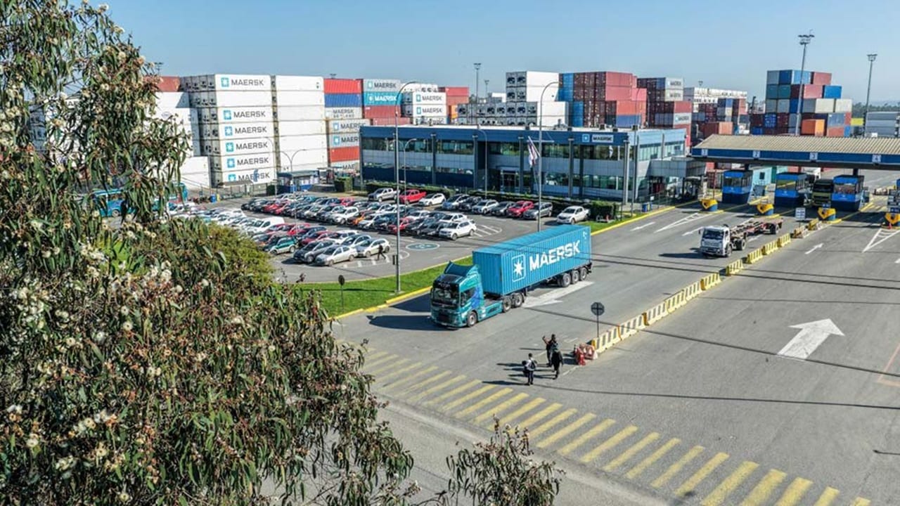 Truck with a Maersk blue container leaving the port
