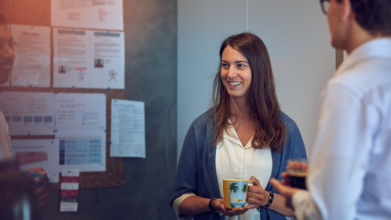 Maersk Customs Services employees standing in front of a board in a meeting.