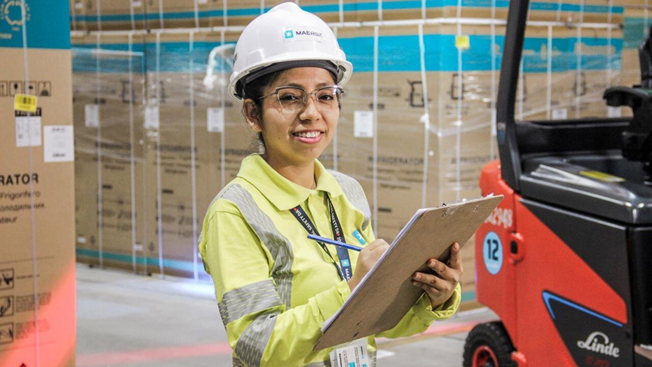 Maersk employee at warehouse with clipboard