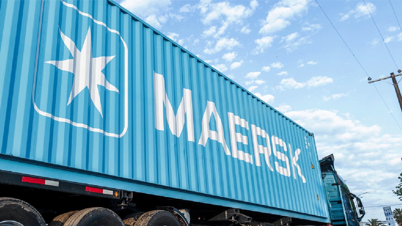 A blue delivery truck featuring the Maersk logo in bold letters.