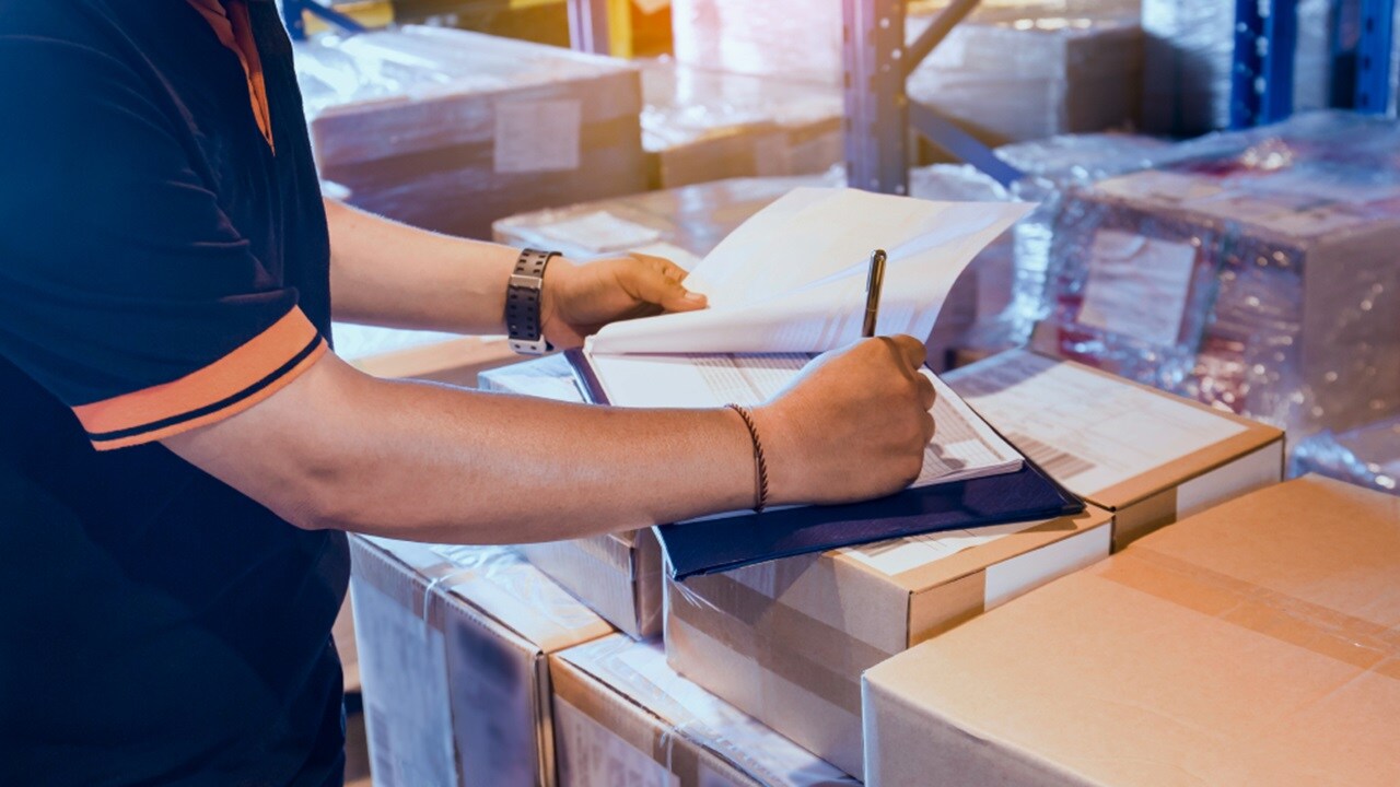 A set of hands filling a form