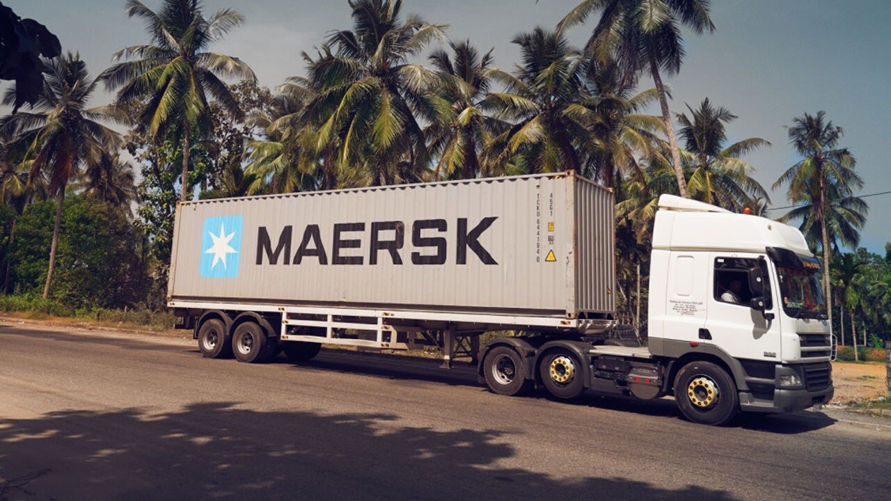 Maersk container on a truck driving on a road