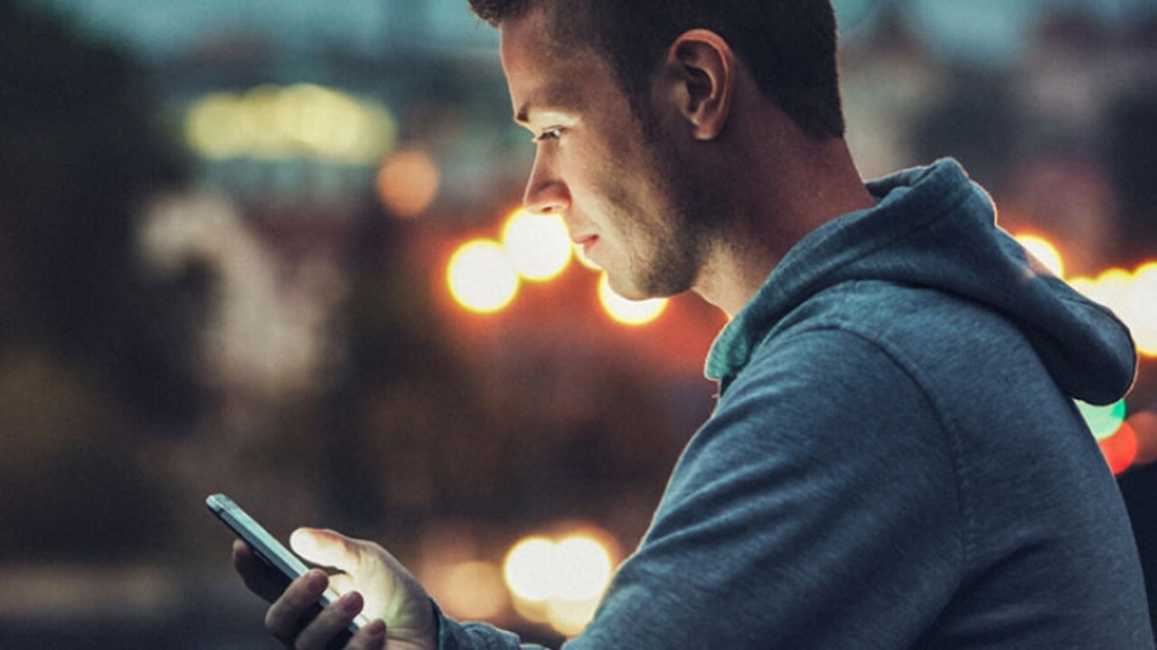 Booking LCL online – a man looking at his mobile phone.