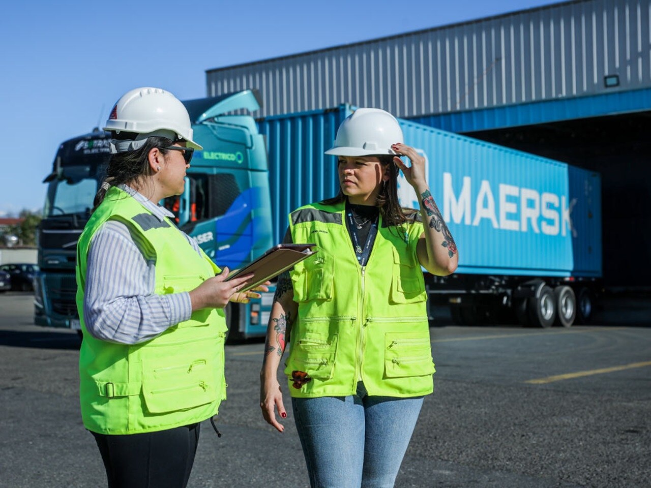Logistics professionals conducting a safety check outside a warehouse facility