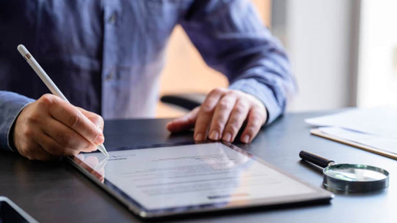 Man signing on contract