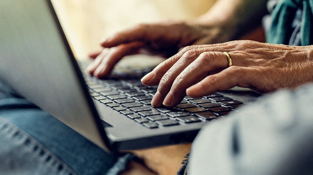 Close up of person working on laptop